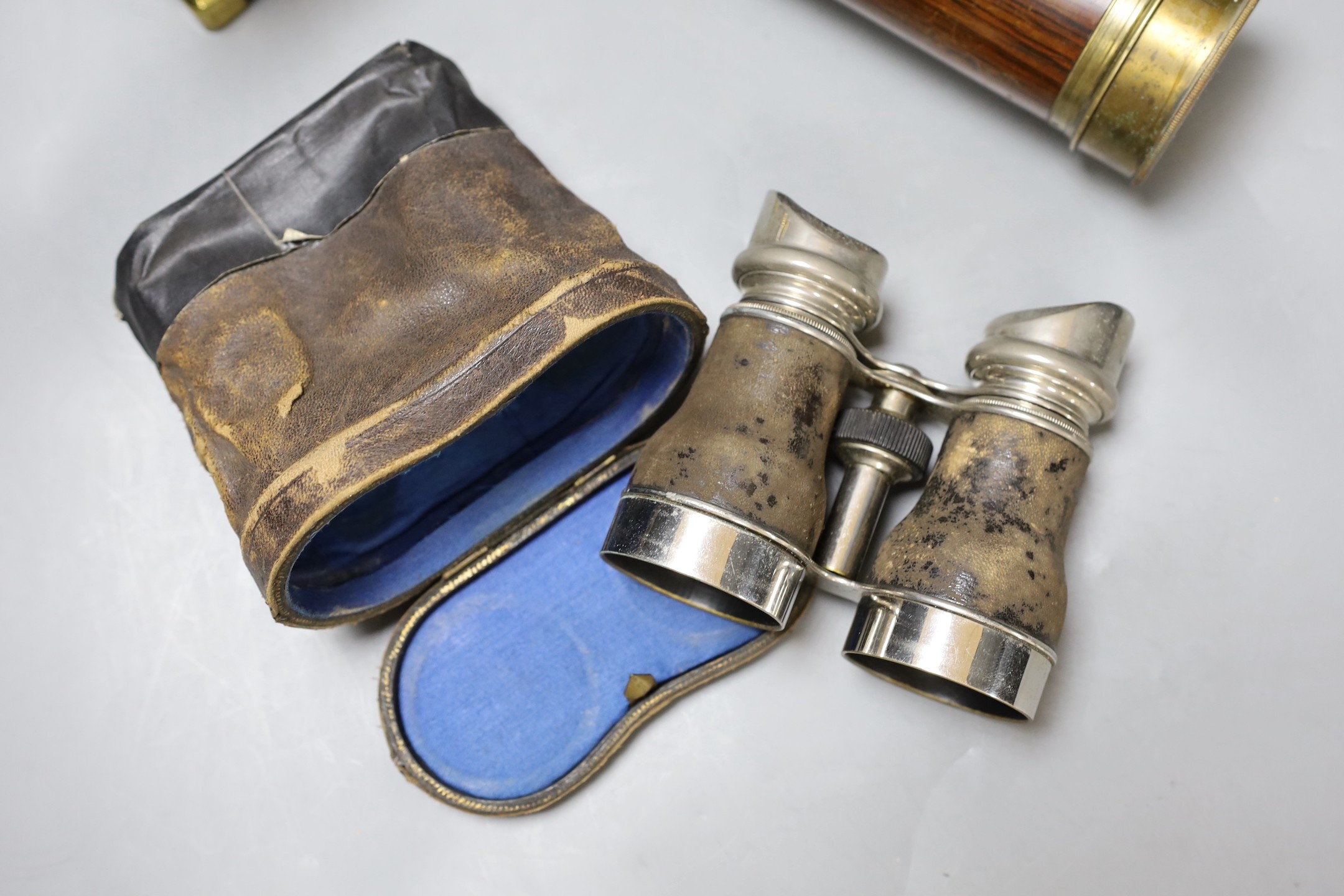 A five draw telescope, a pair of cased binoculars, postal scales and a brass timepiece, telescope drawn 69 cms long